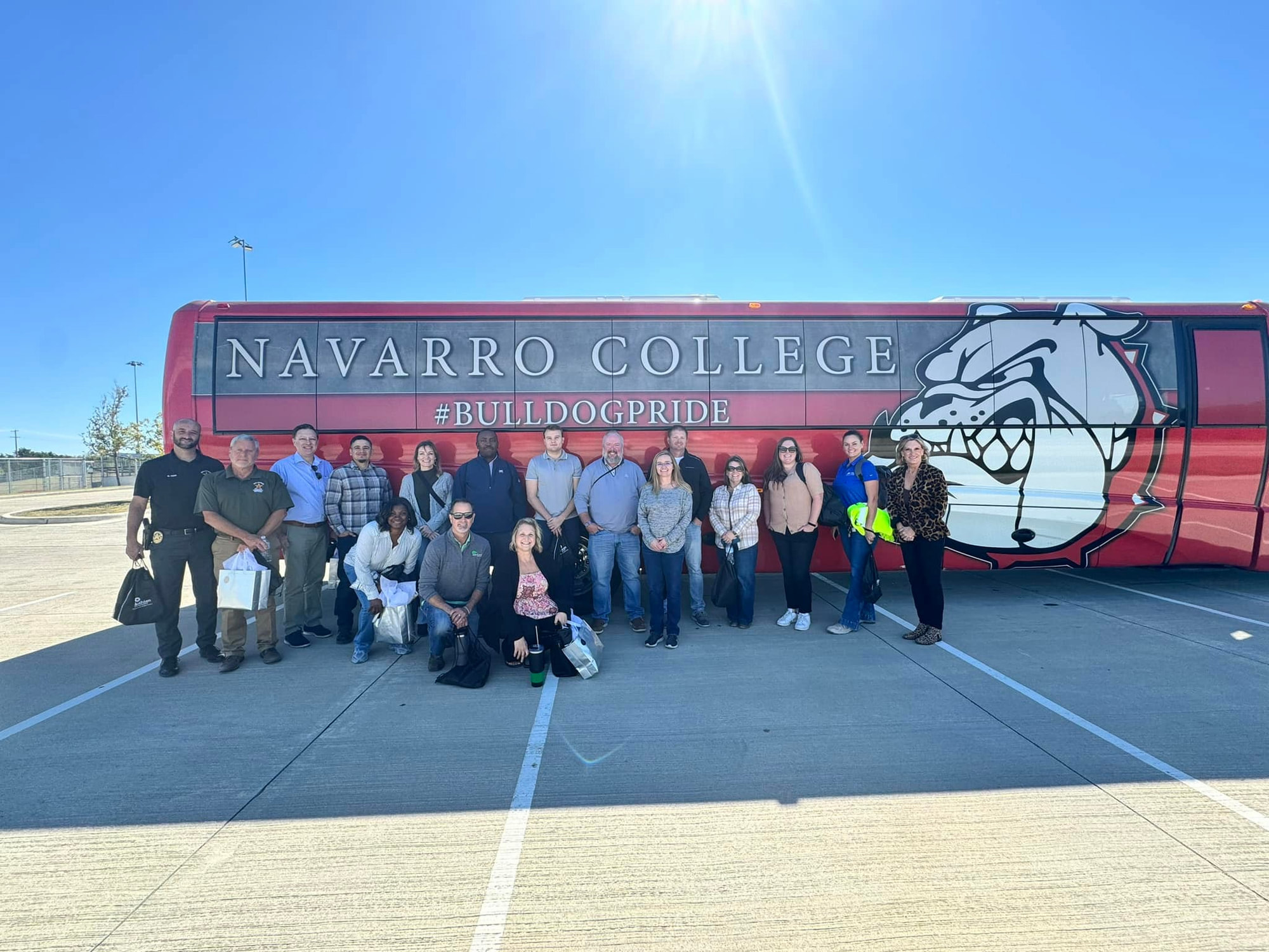 Leadership Midlothian group standing in front of Navarro College shuttle bus