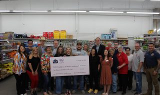 MISD Education Foundation posing with the U.S. LBM Humanitarian Award