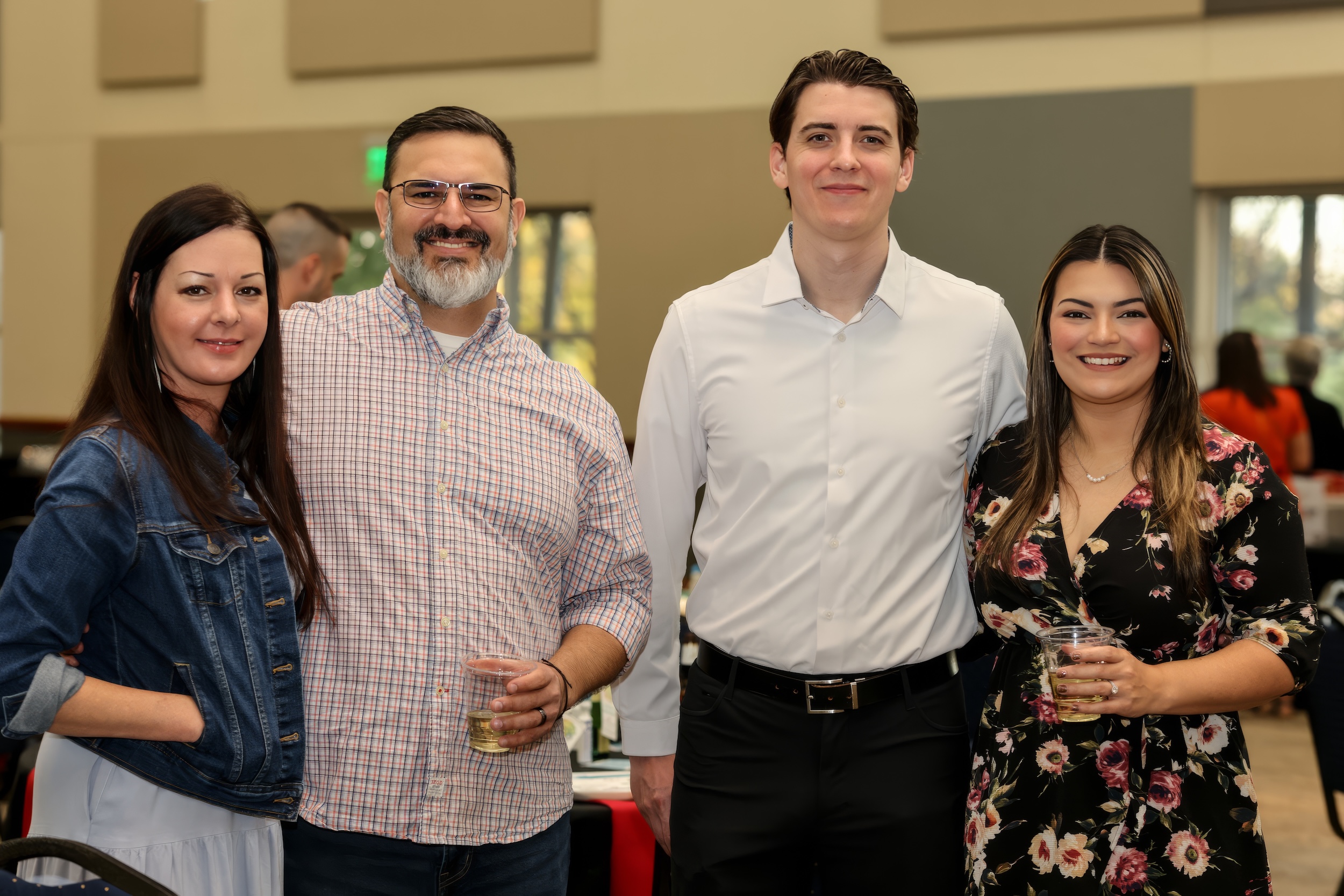Group smiling and holding drinks at Chamber Bingo Night