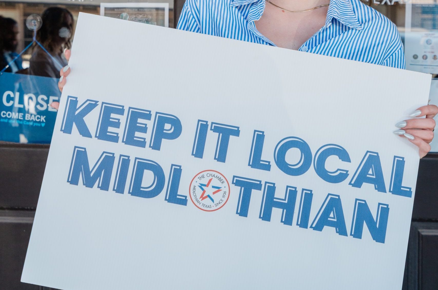 Midlothian Chamber staff holding a sign that reads "Keep It Local Midlothian"