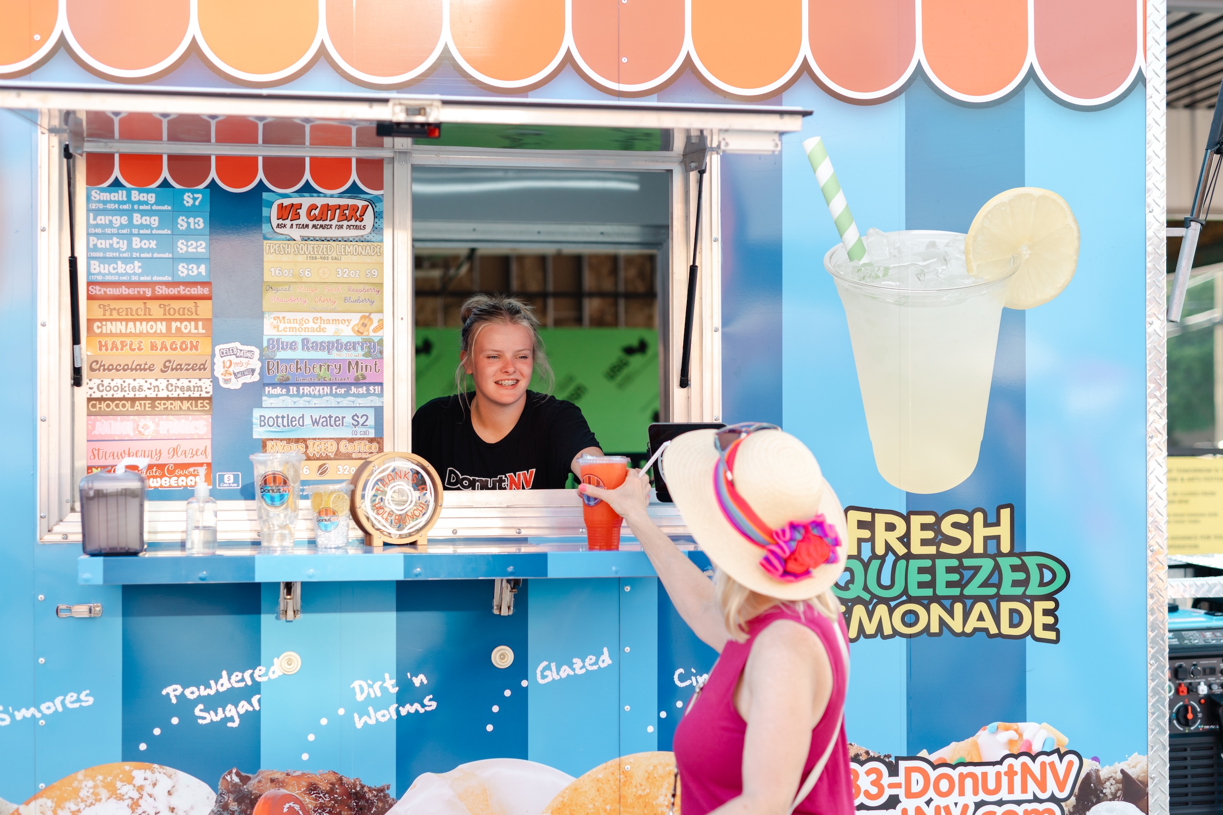 Chamber MidloFest lemonade truck handing woman drink through the window