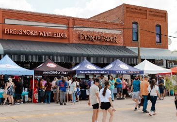 People walking through busy street of Chamber MidloFest vendors