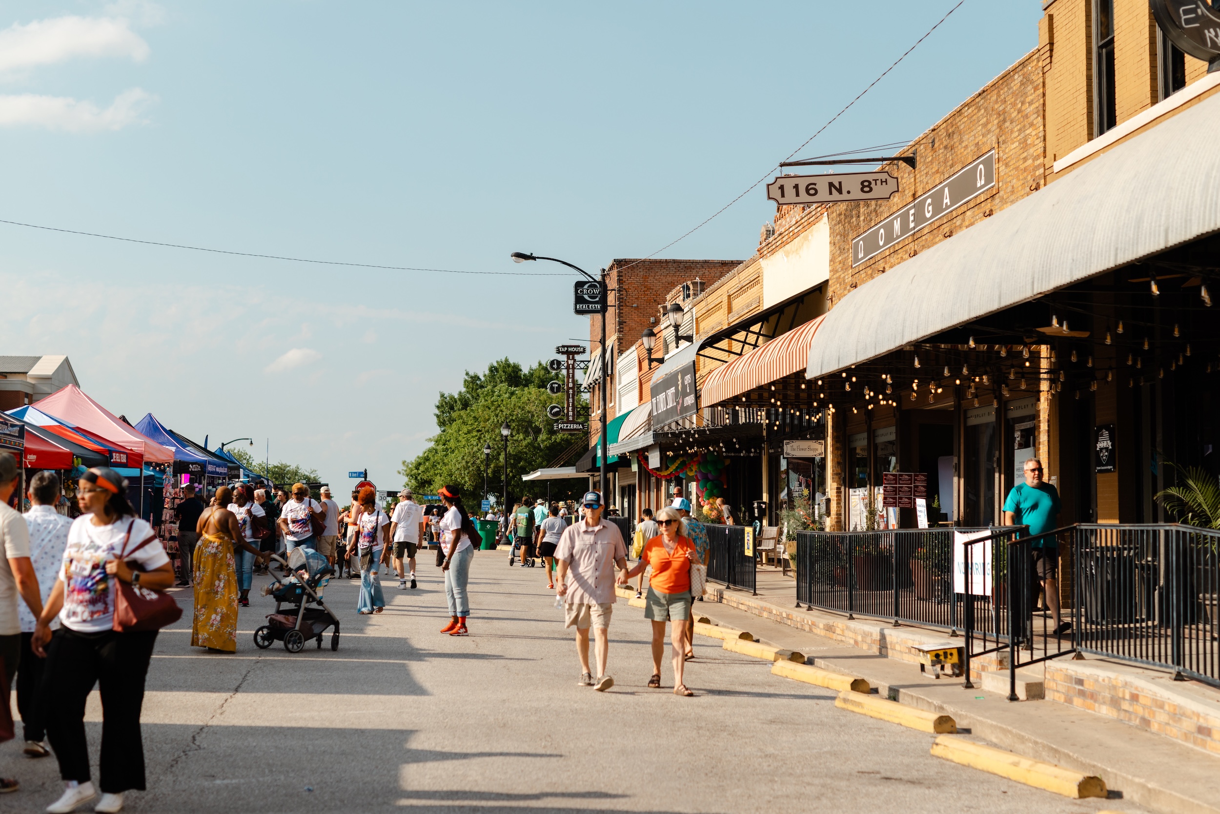People walking busy street of Chamber MidloFest vendors