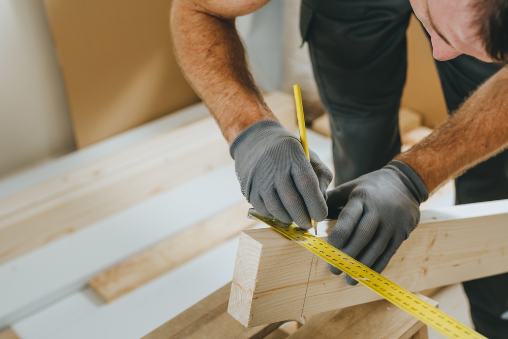 Carpenter measuring wooden board