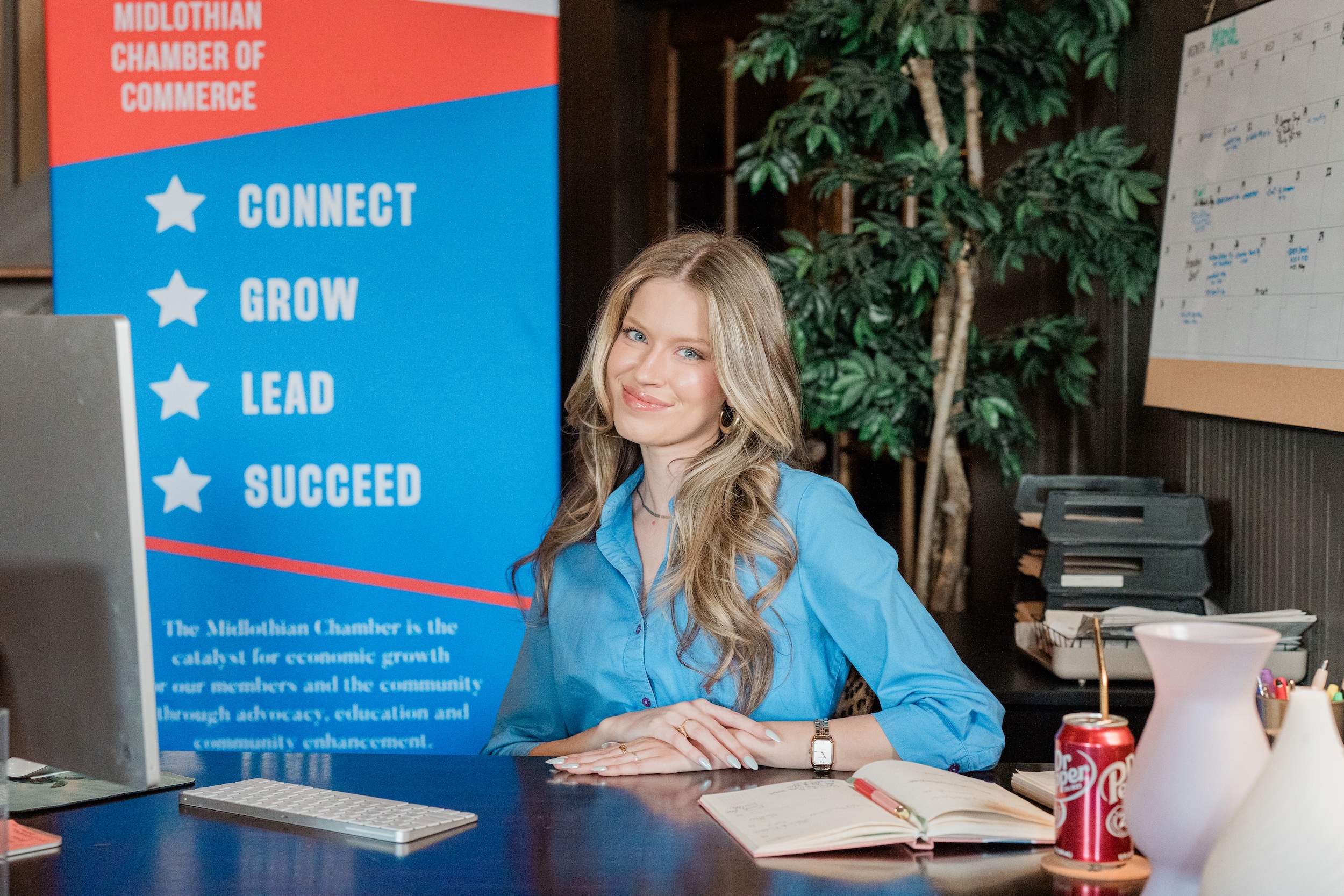Kenna Standridge posing at desk in Midlothian Chamber office