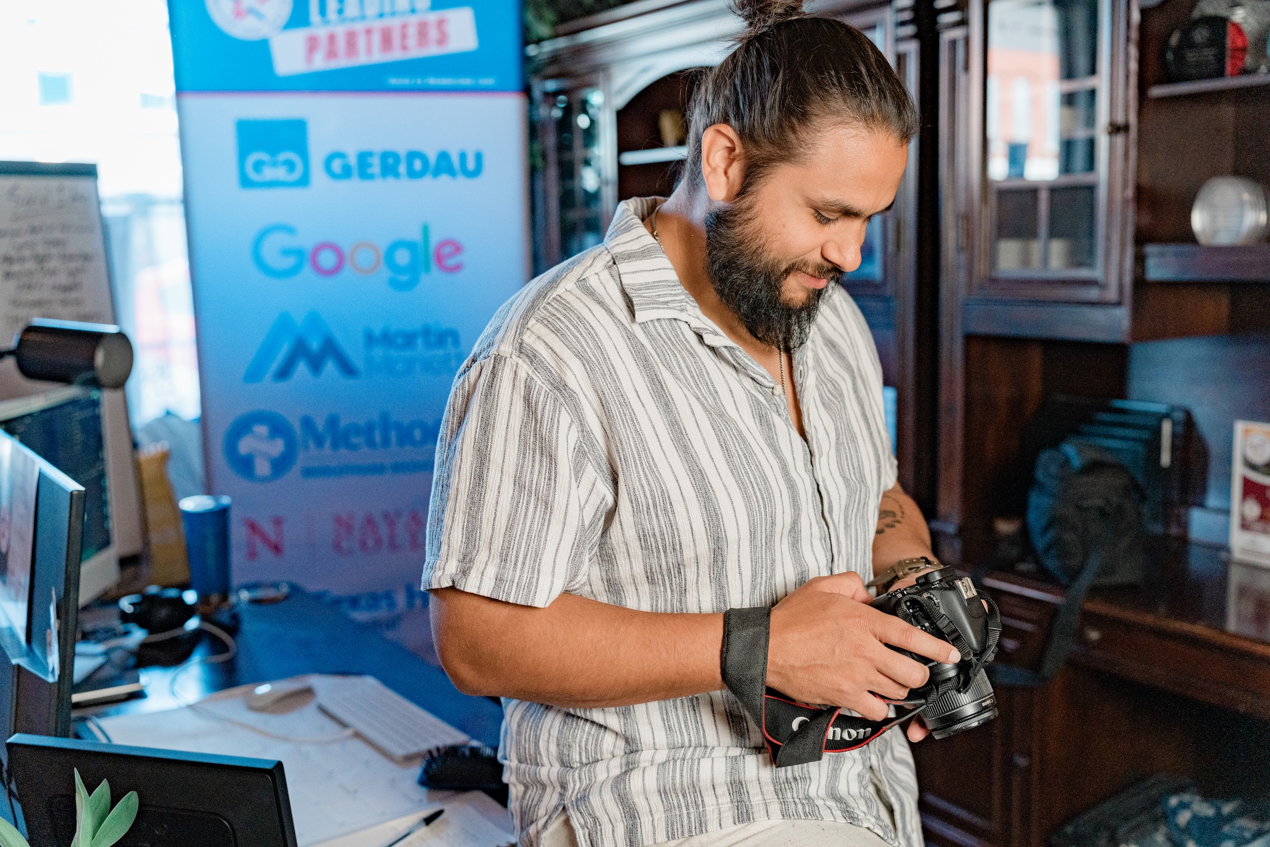 Alec Martinez looking at photos on camera in Midlothian Chamber office