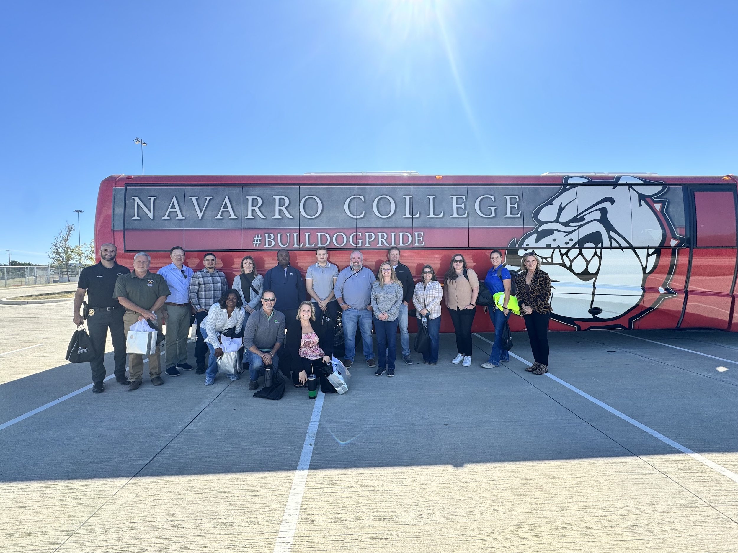 Leadership Midlothian group standing in front of Navarro College shuttle bus
