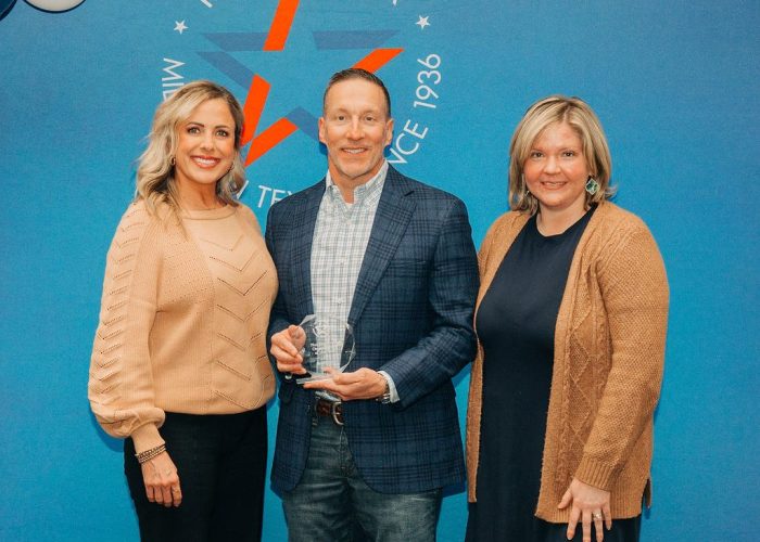 Mentors Care receiving Non-Profit of the Year award